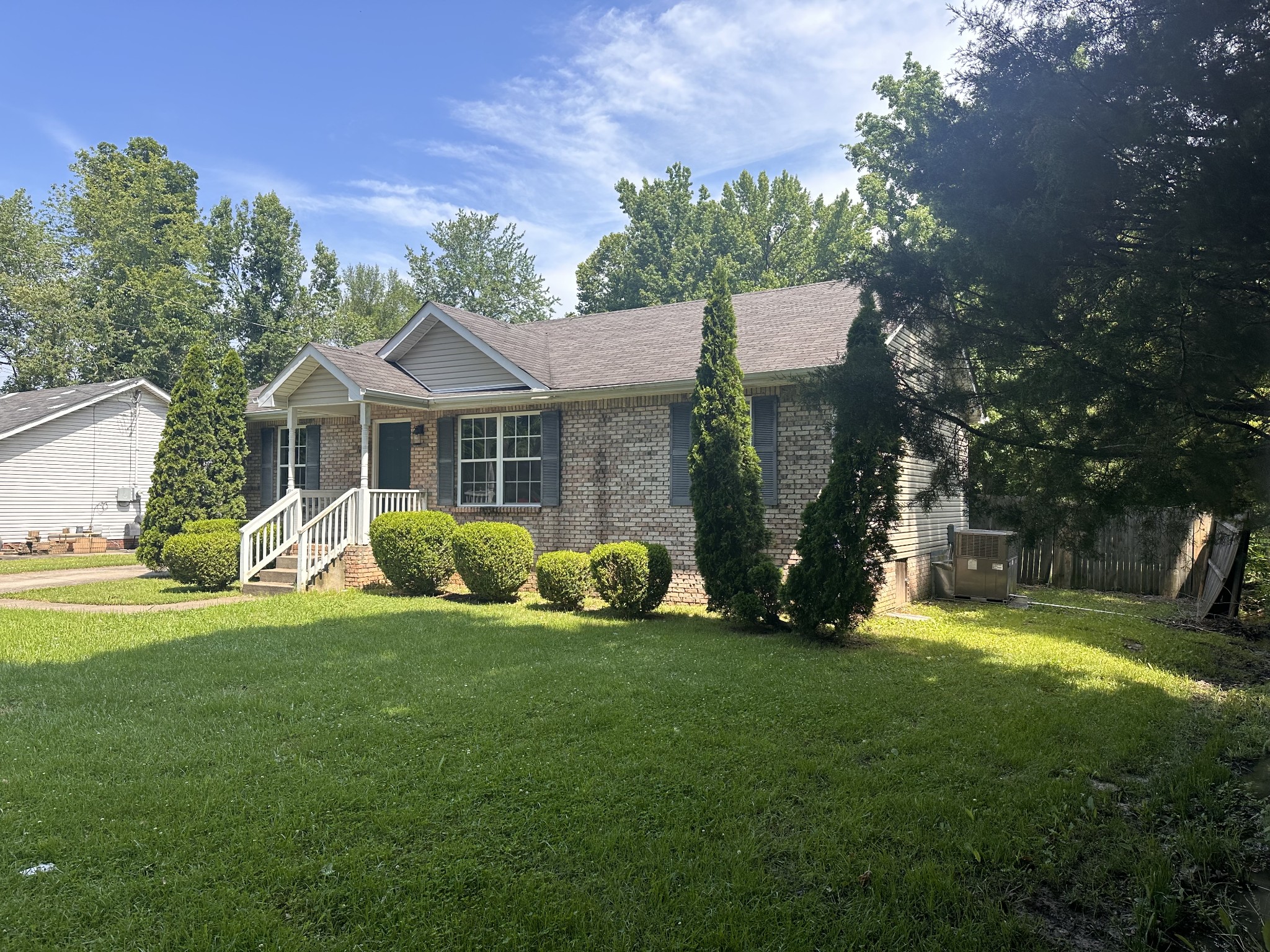 a view of a house with a yard and sitting area