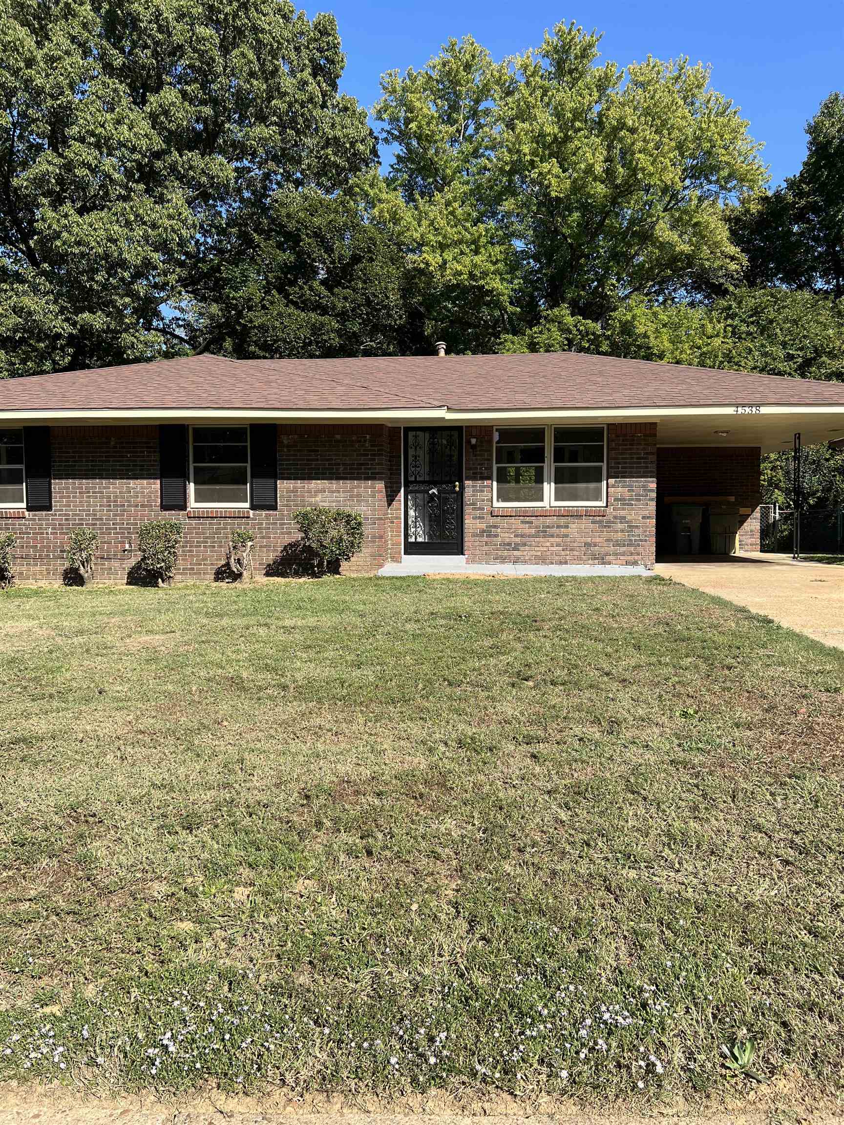 a view of a house with yard and sitting area