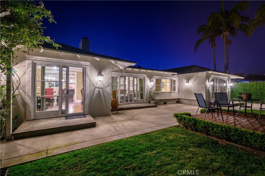 a view of a house with backyard porch and sitting area