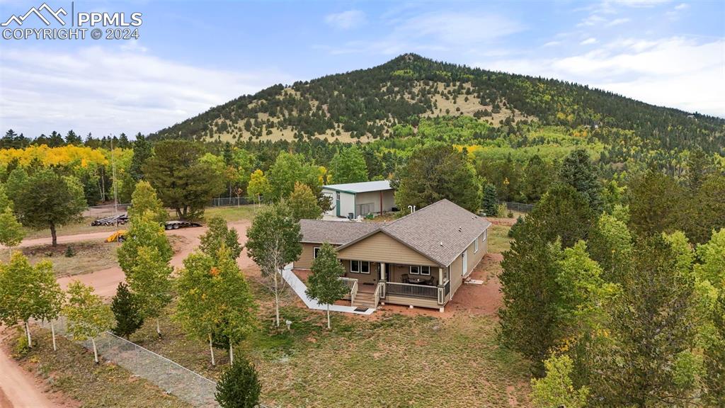 a view of a big house with a mountain in the background