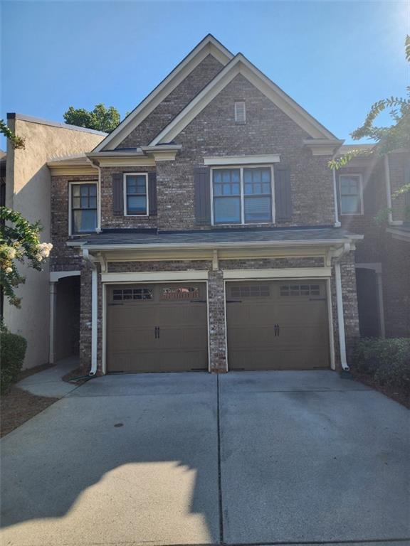 a front view of a house with a garage