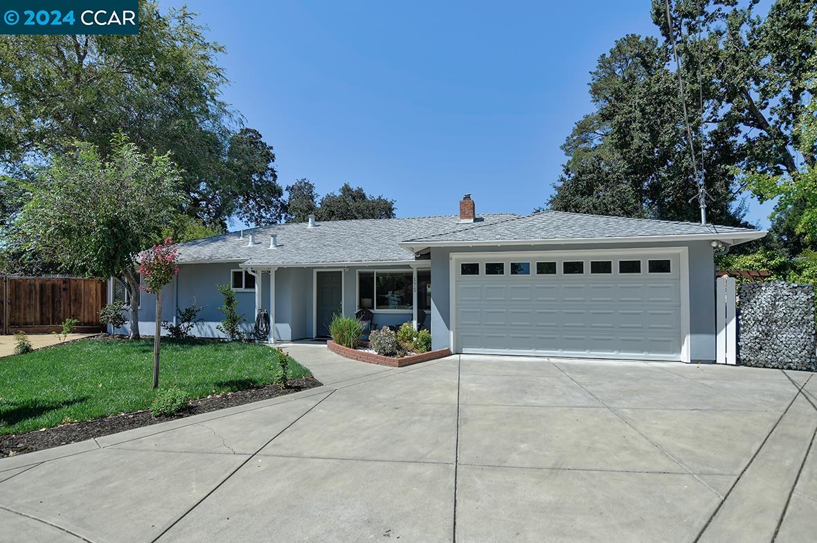 a view of a house with outdoor space and parking