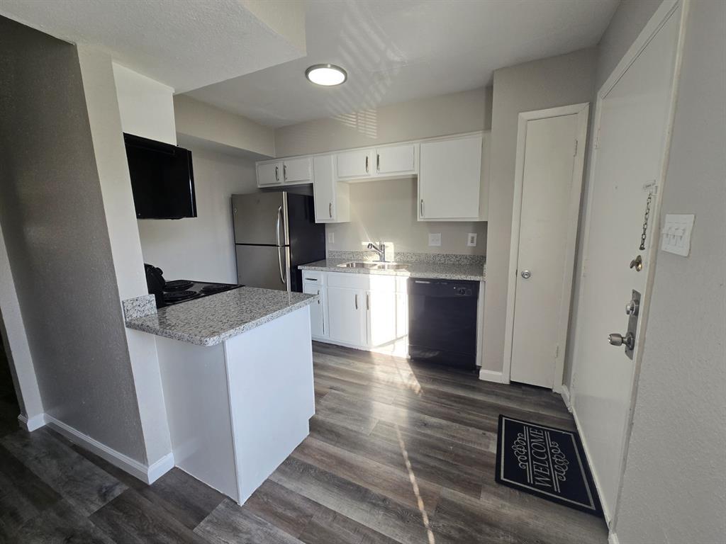 a kitchen with stainless steel appliances granite countertop a refrigerator and a stove