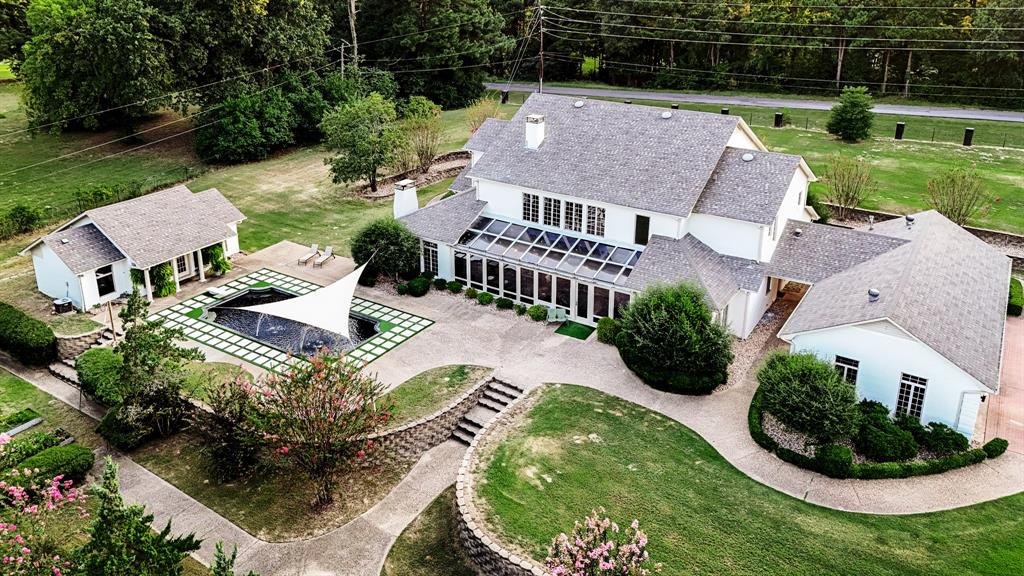 an aerial view of a house with garden space and lake view