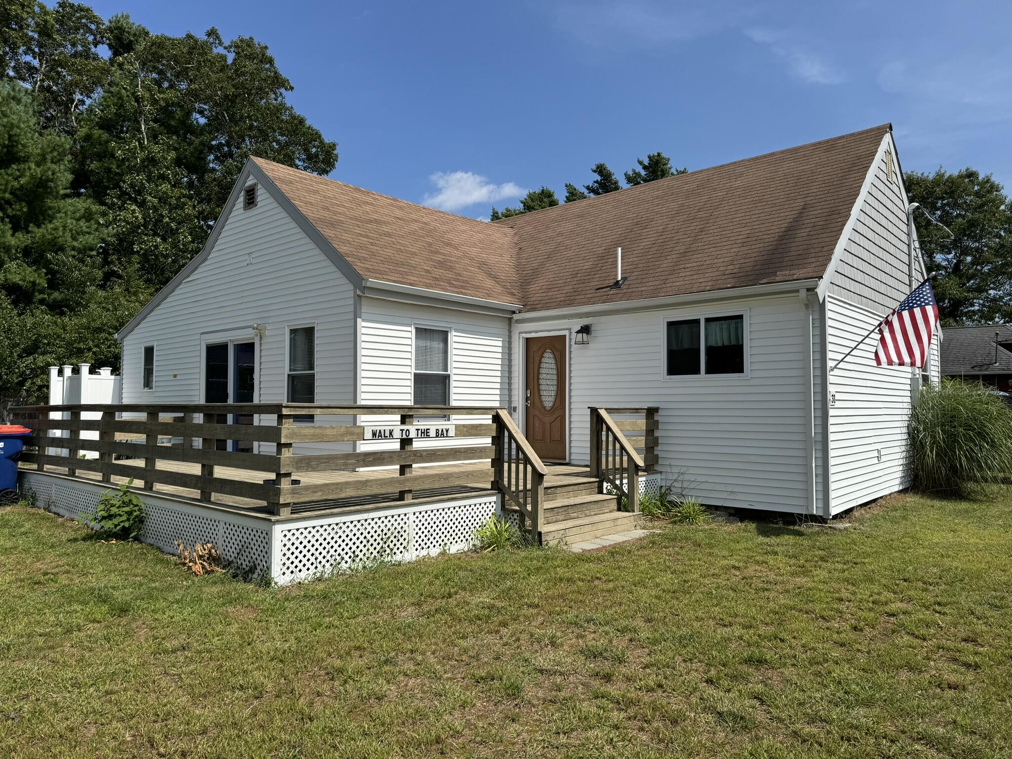 a view of a house with backyard and sitting area