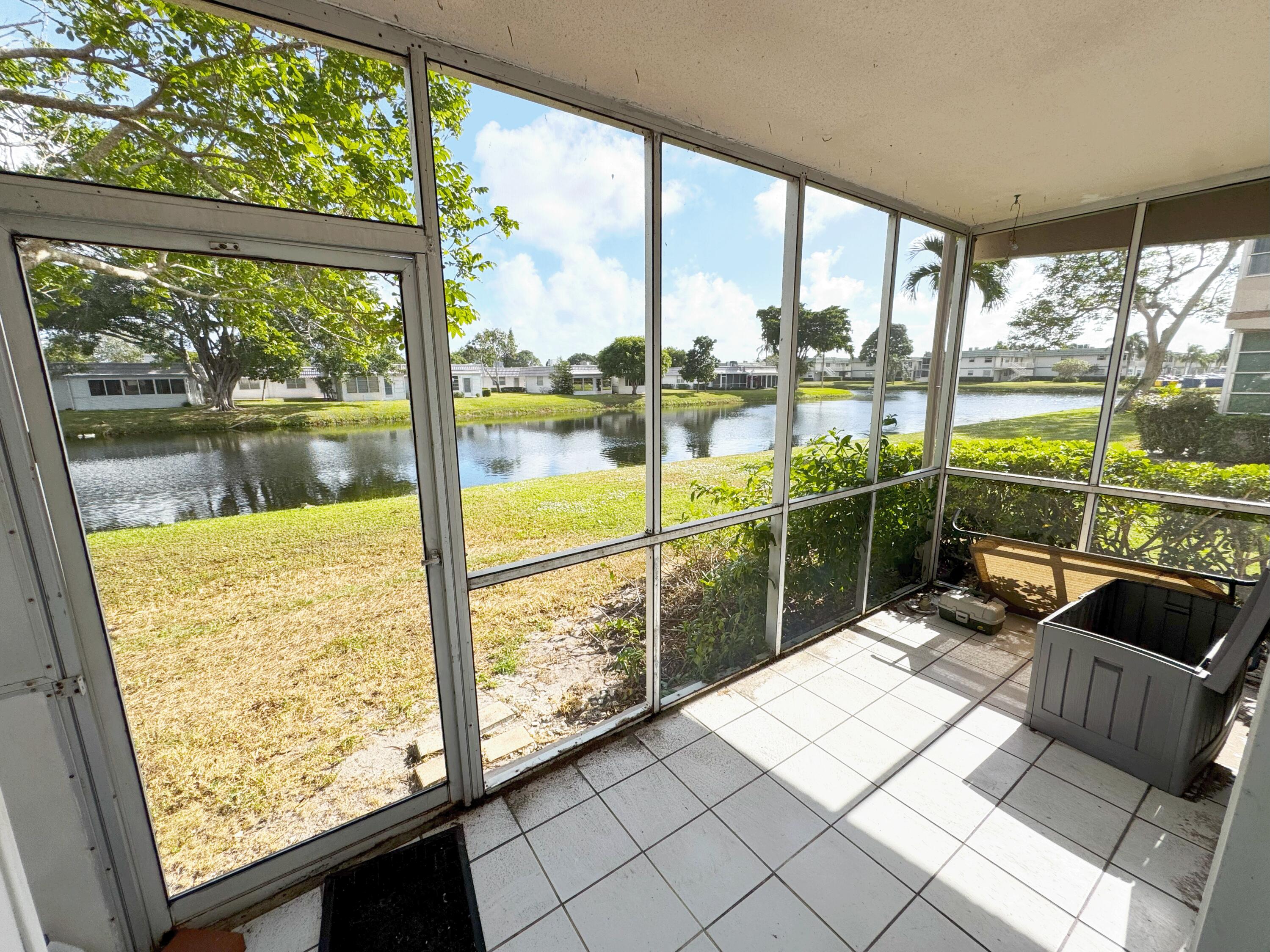 a view of a floor to ceiling window next to a yard