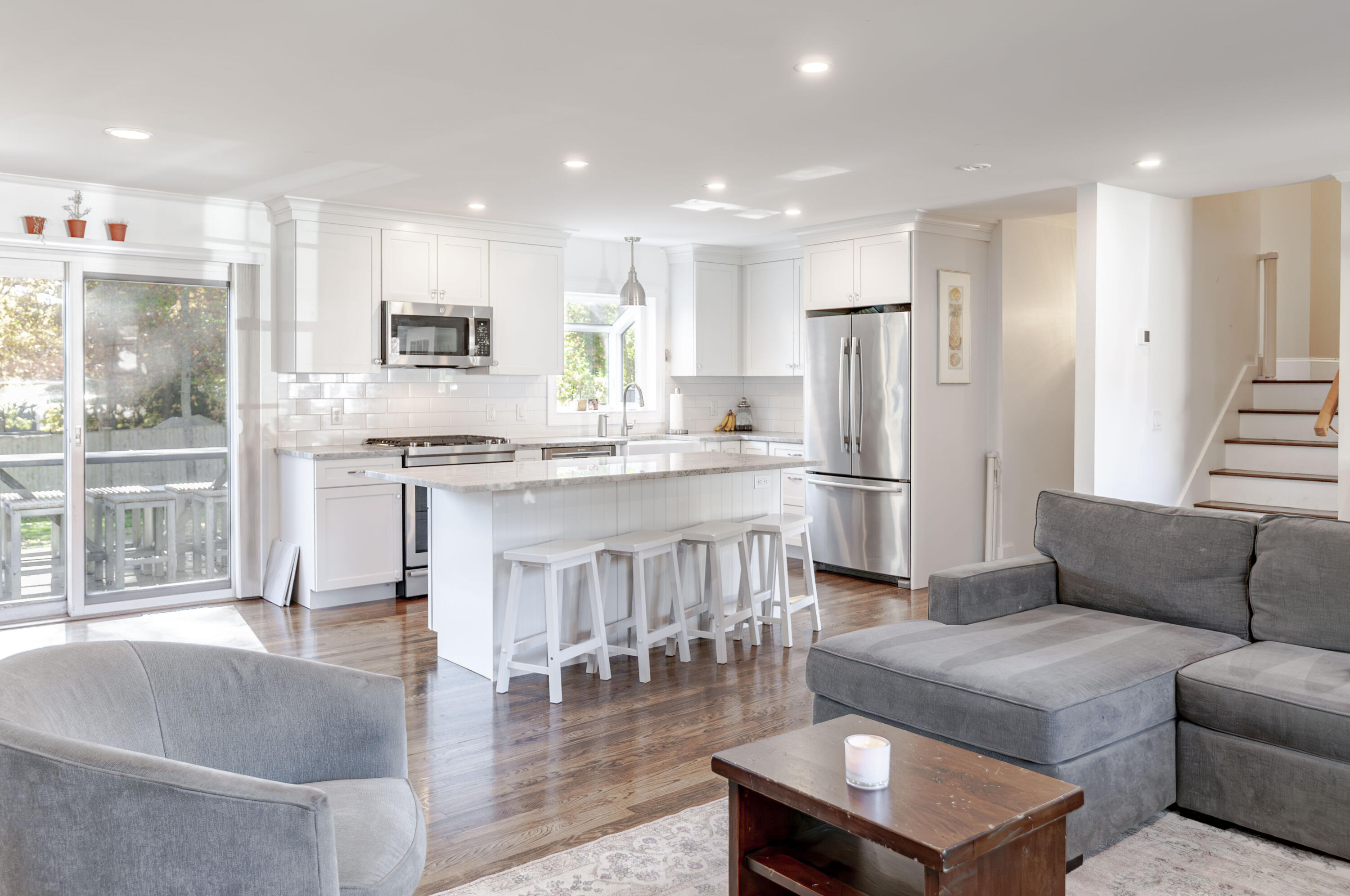 a living room with stainless steel appliances kitchen island granite countertop furniture and a kitchen view