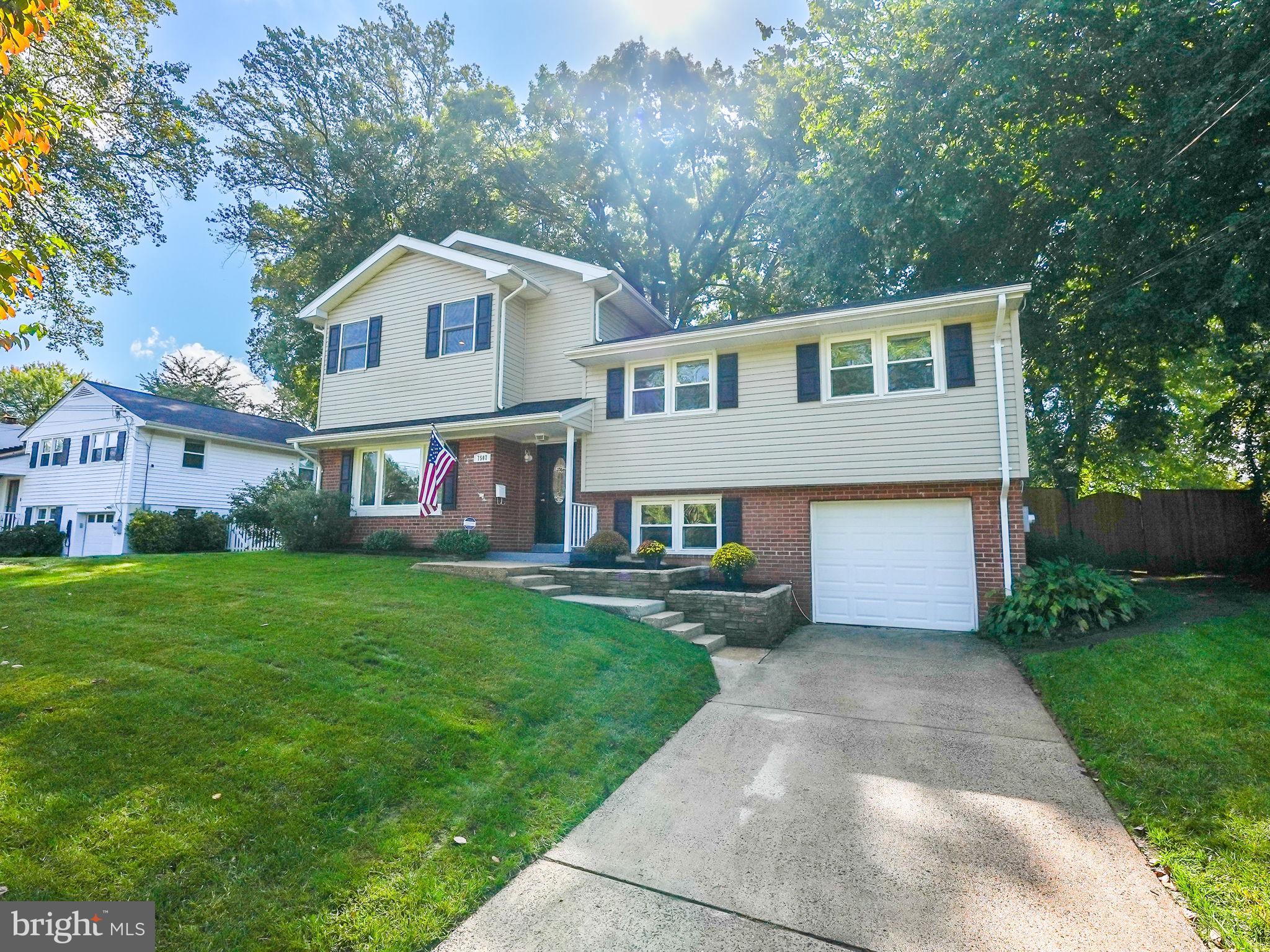 a front view of house with yard and green space