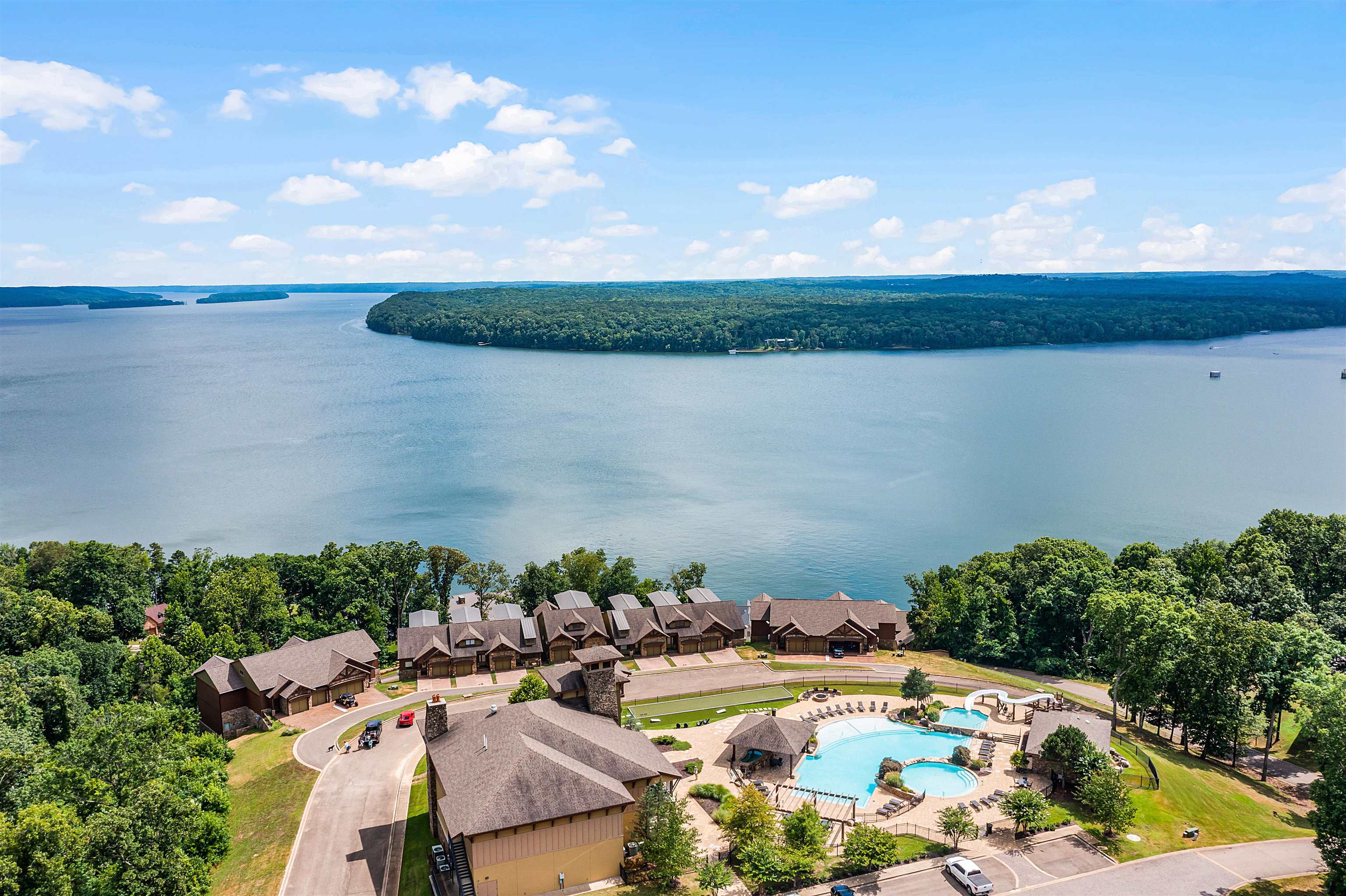 a view of a lake with lawn chairs