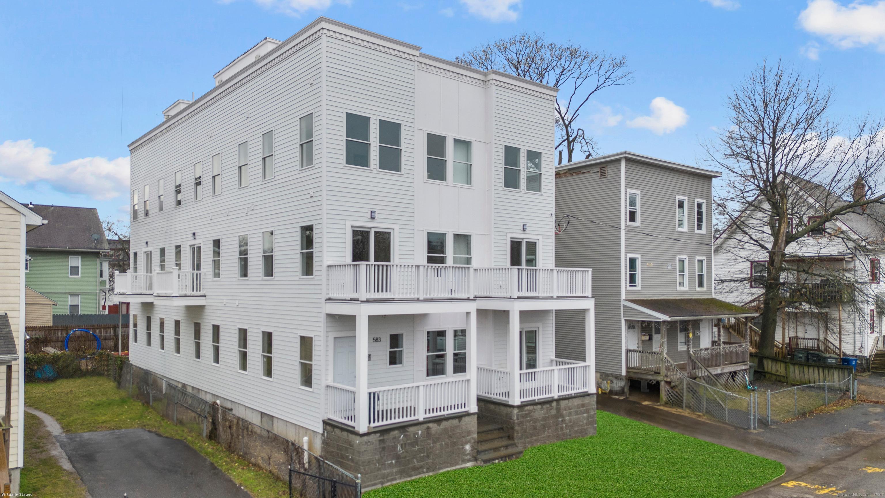 a large white building with a yard in front of it