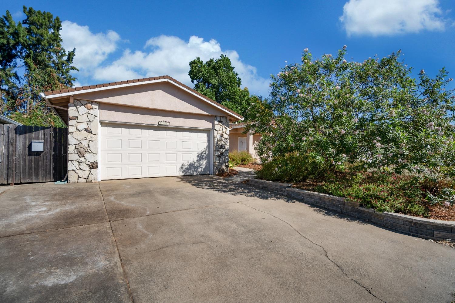 a view of a house with a yard and garage