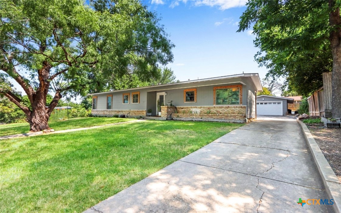 a front view of house with yard having outdoor seating