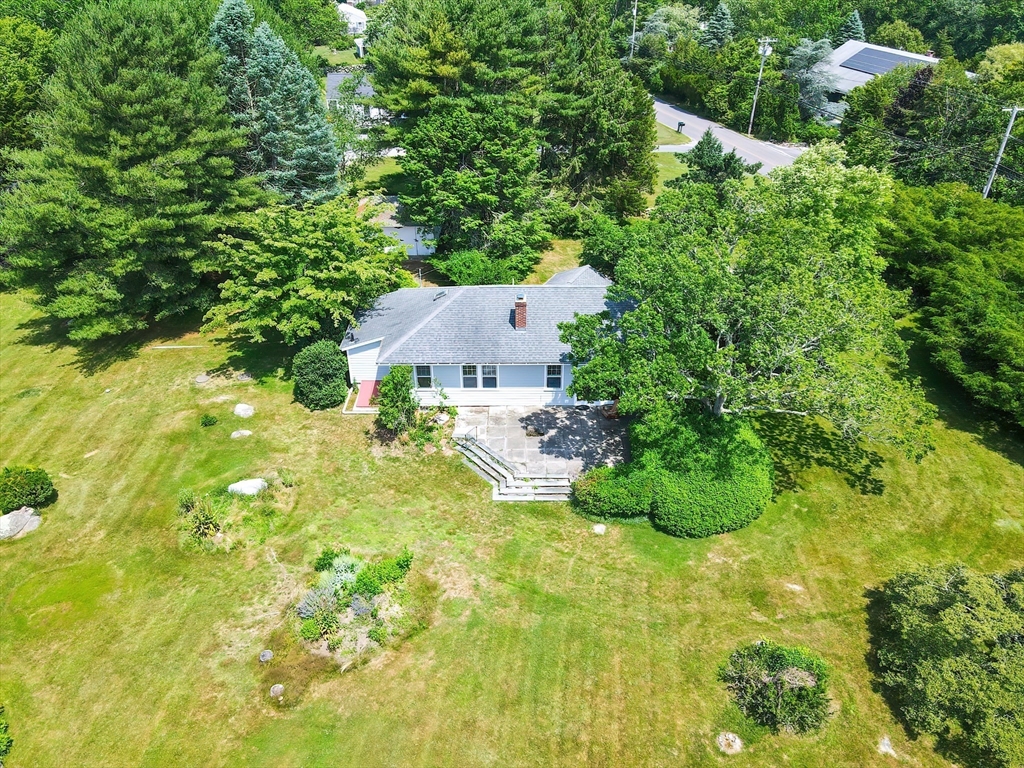 an aerial view of residential house with swimming pool and lawn chairs