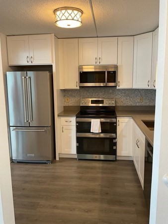 a kitchen with stainless steel appliances a refrigerator stove and microwave