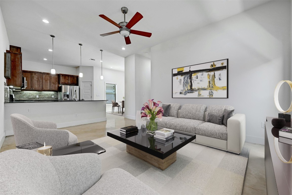 a living room with furniture kitchen view and a window