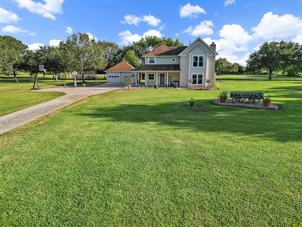 a view of a big yard with a house in the background