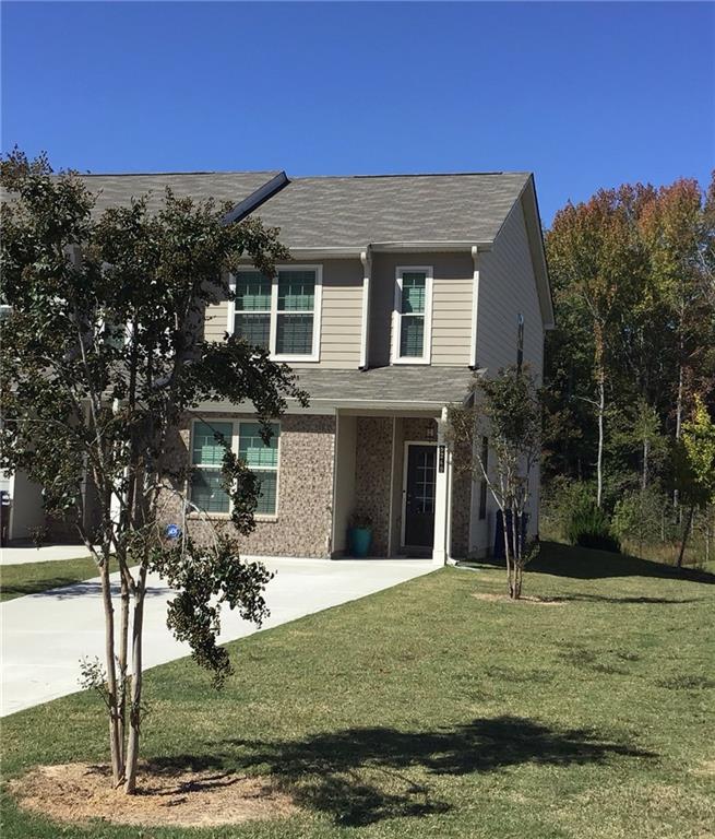 a front view of a house with a yard