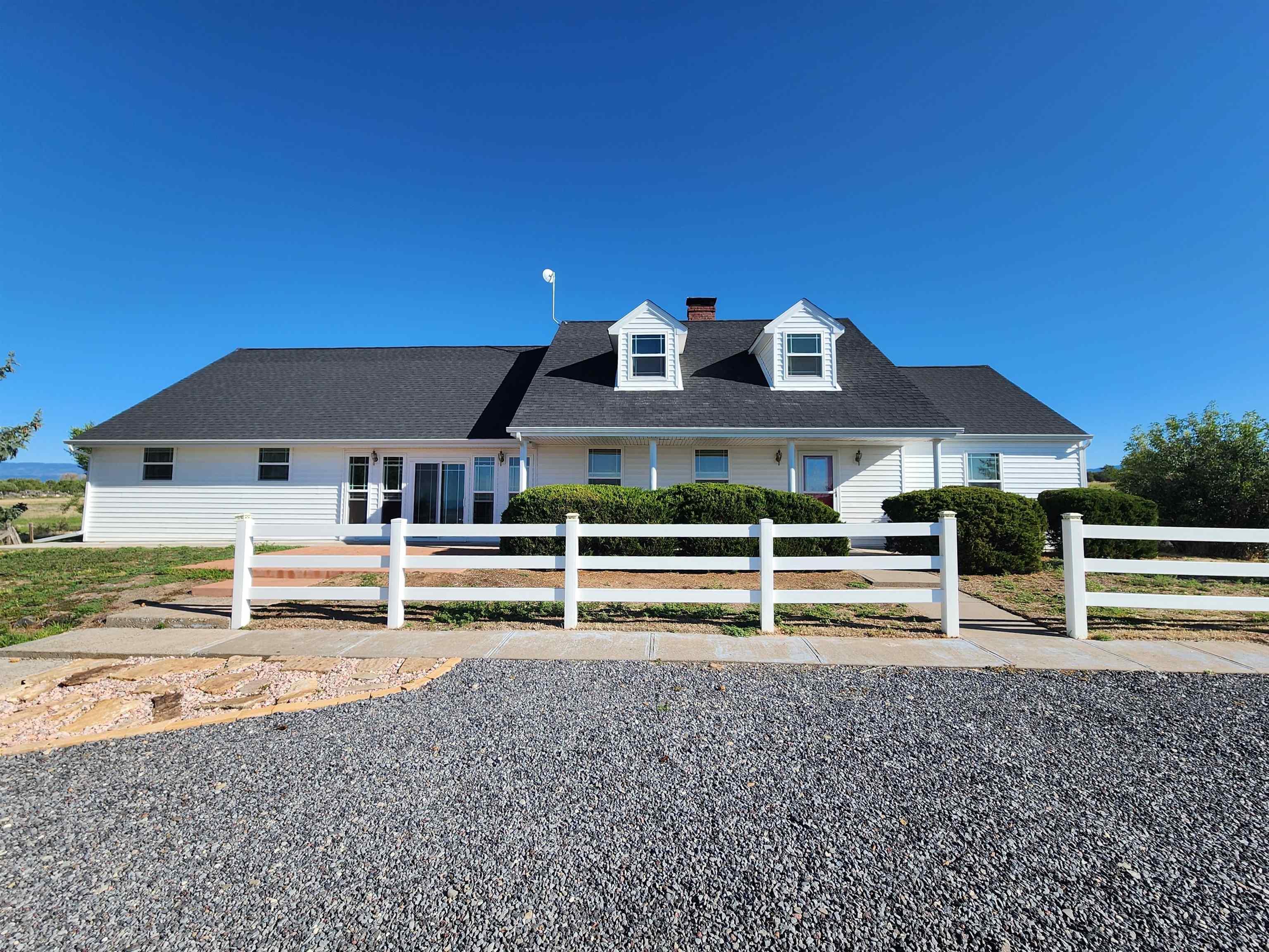 a front view of a house with wooden fence