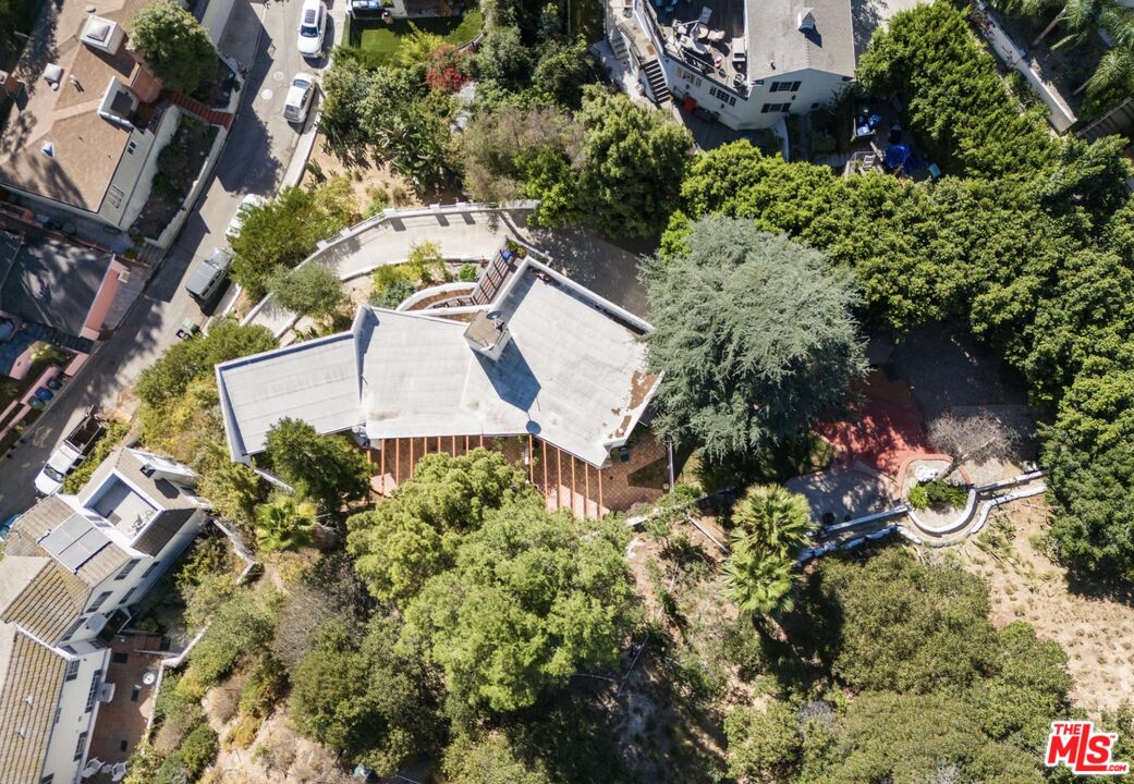 an aerial view of a house with a yard and garden