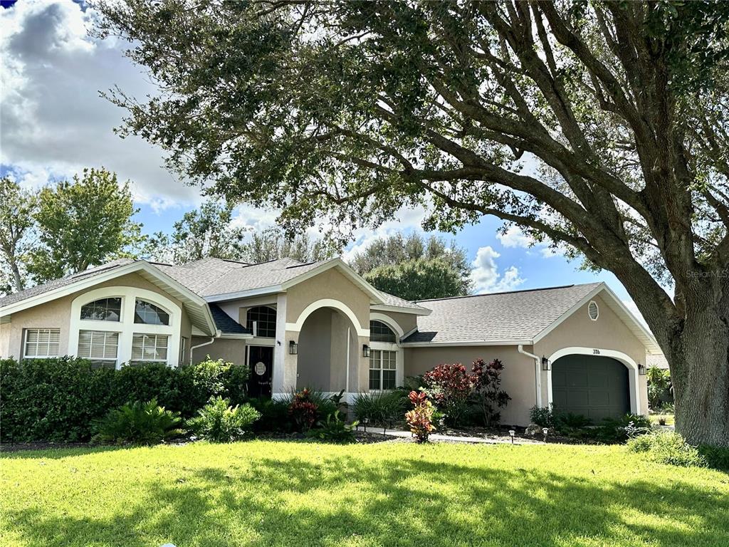 a front view of house with yard and green space