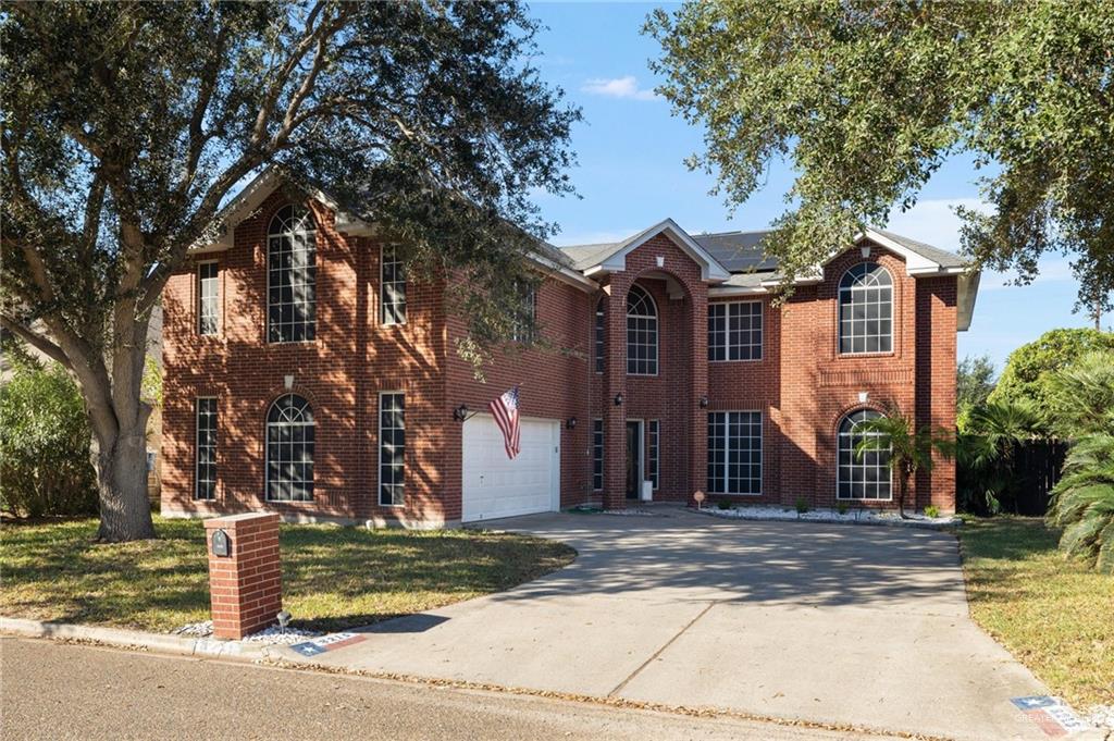 Colonial inspired home with a garage and solar panels