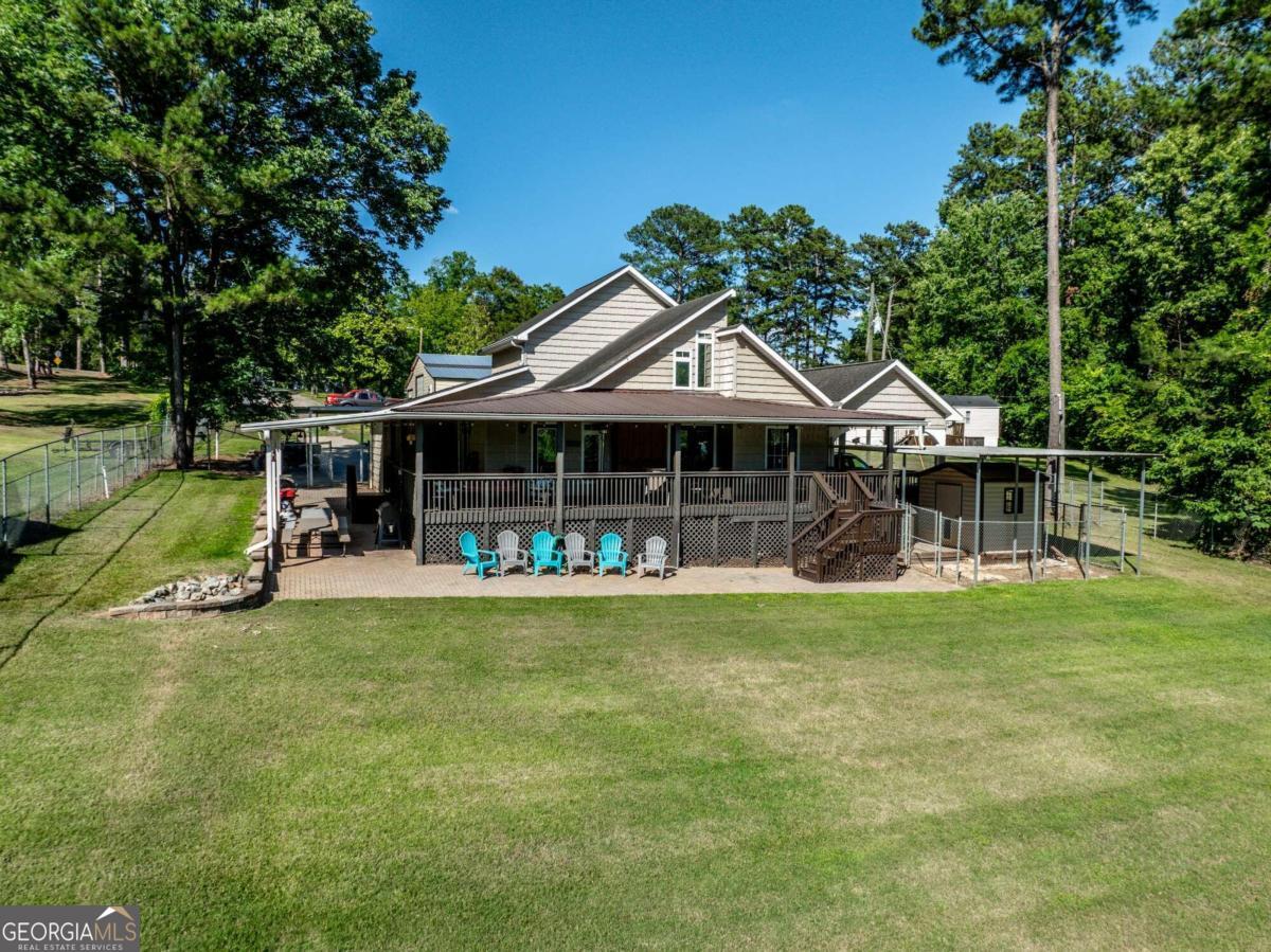 a front view of a house with a garden and trees