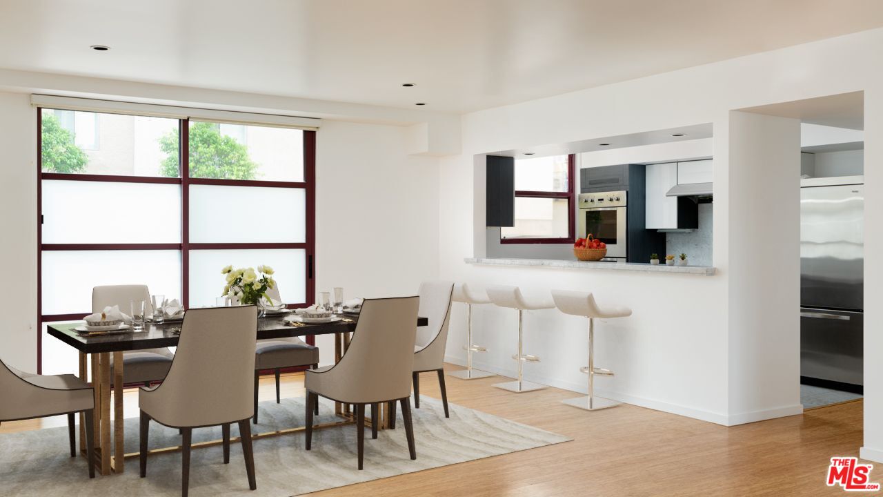 a view of a dining room with furniture and a window