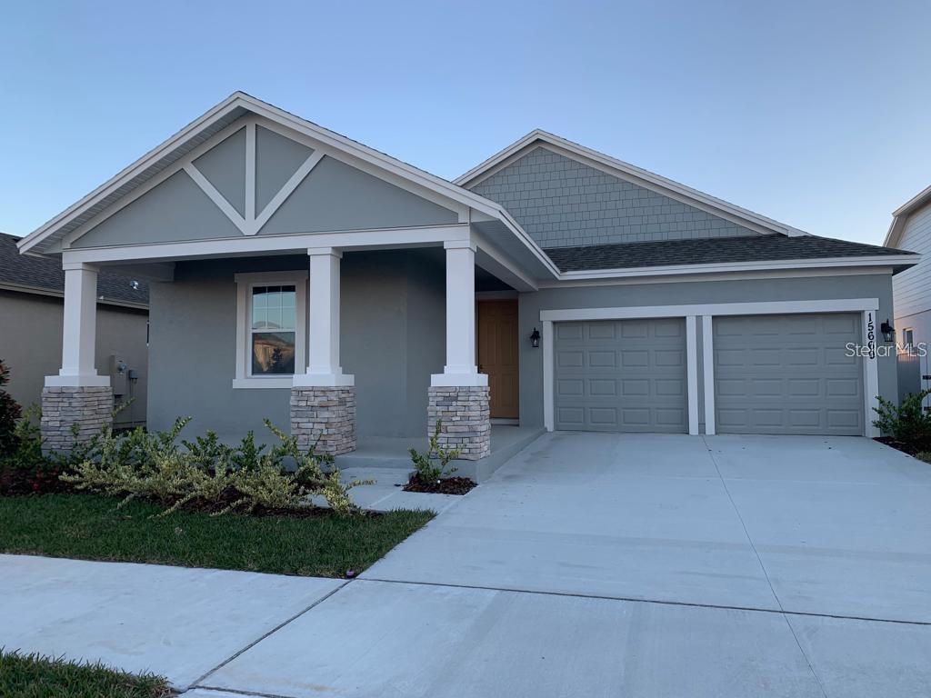 a front view of a house with garage and yard