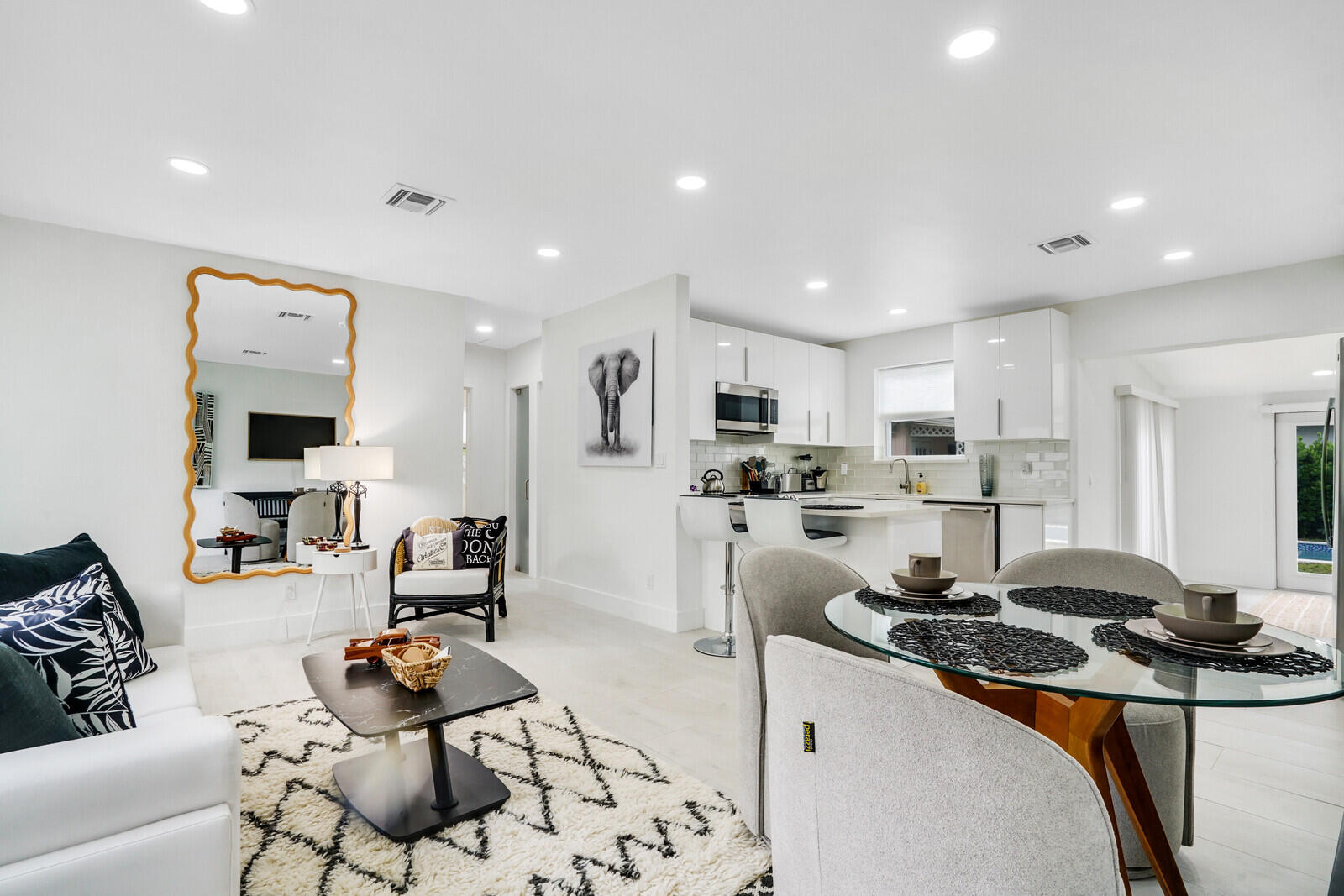 a kitchen with stainless steel appliances kitchen island granite countertop a sink and cabinets