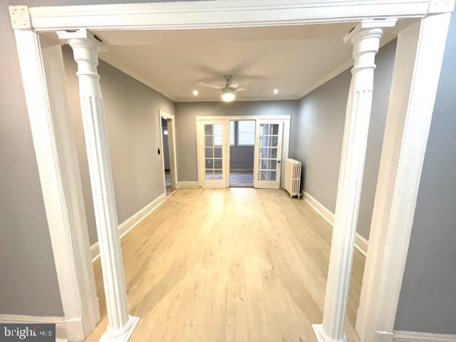 a view of a big room with wooden floor and windows