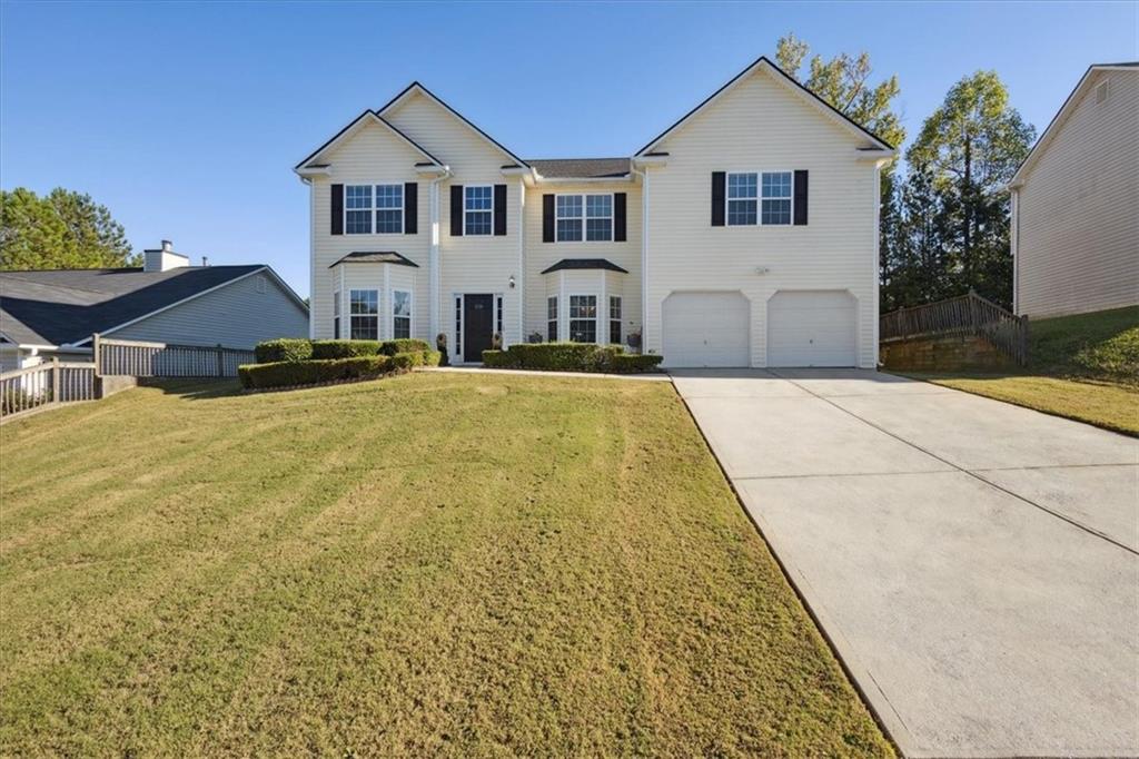 a front view of a house with yard