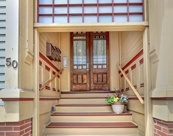 a view of entryway and hall with wooden floor