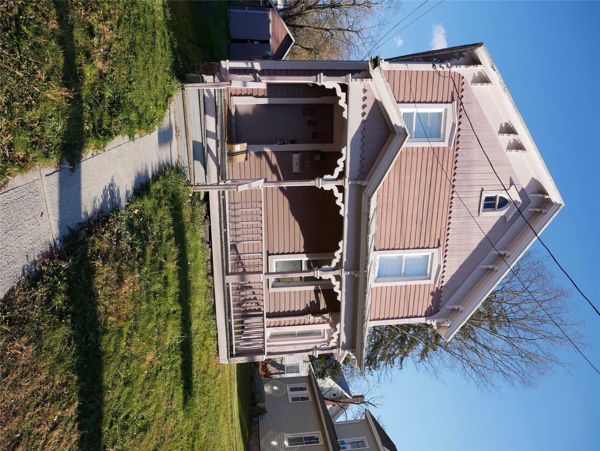 a front view of a house with a yard table and chairs