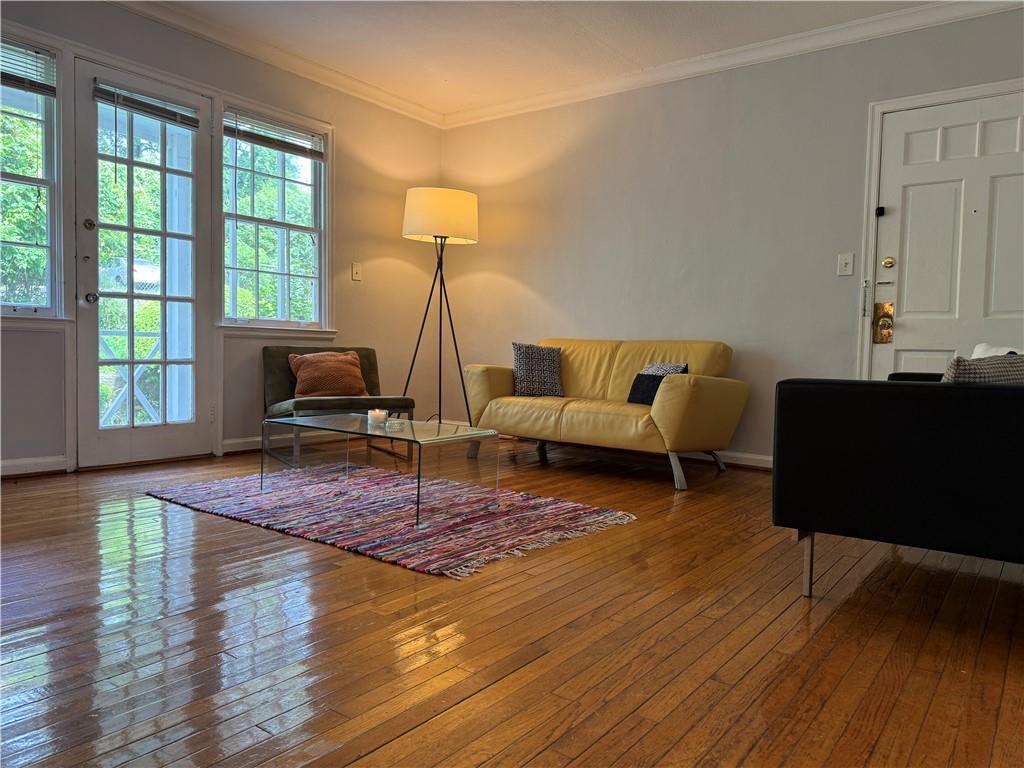 a living room with furniture and a wooden floor