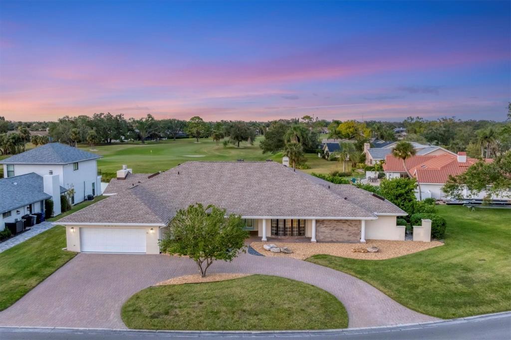 an aerial view of a house with a garden and a yard