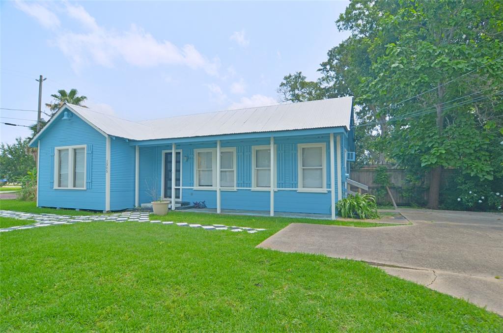 a view of a house with a yard and sitting area