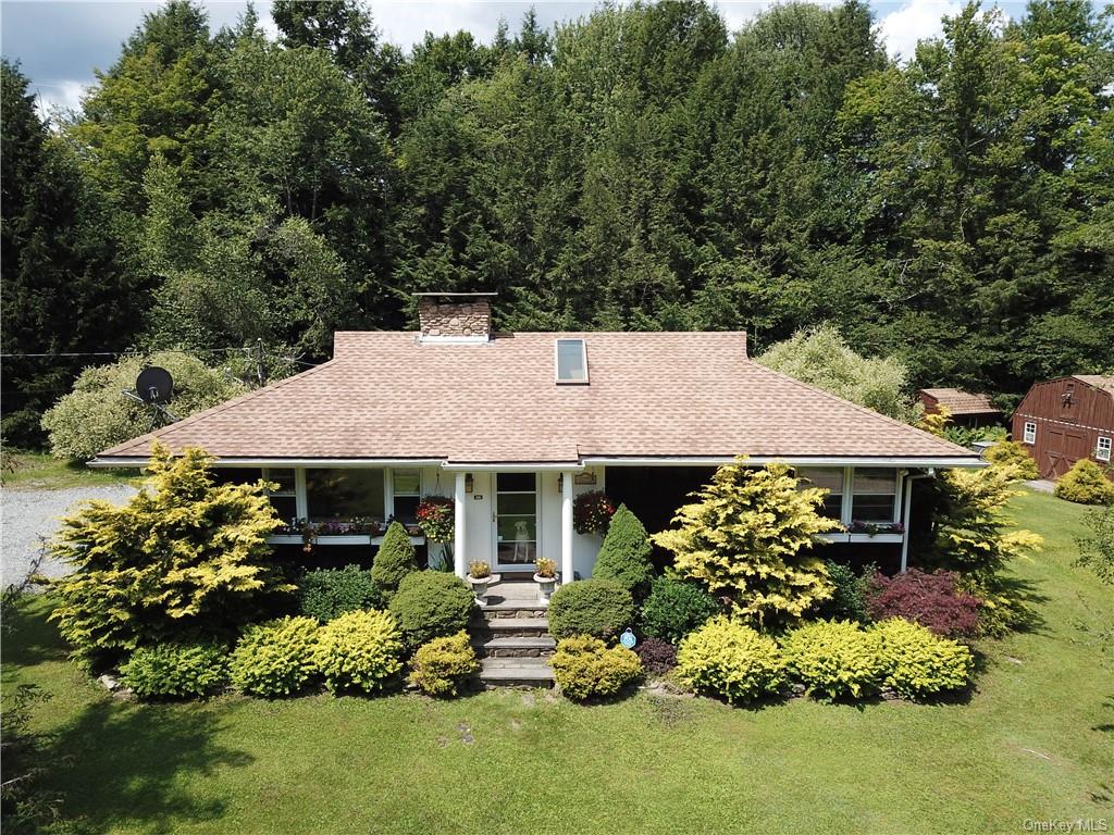 a front view of a house with a garden