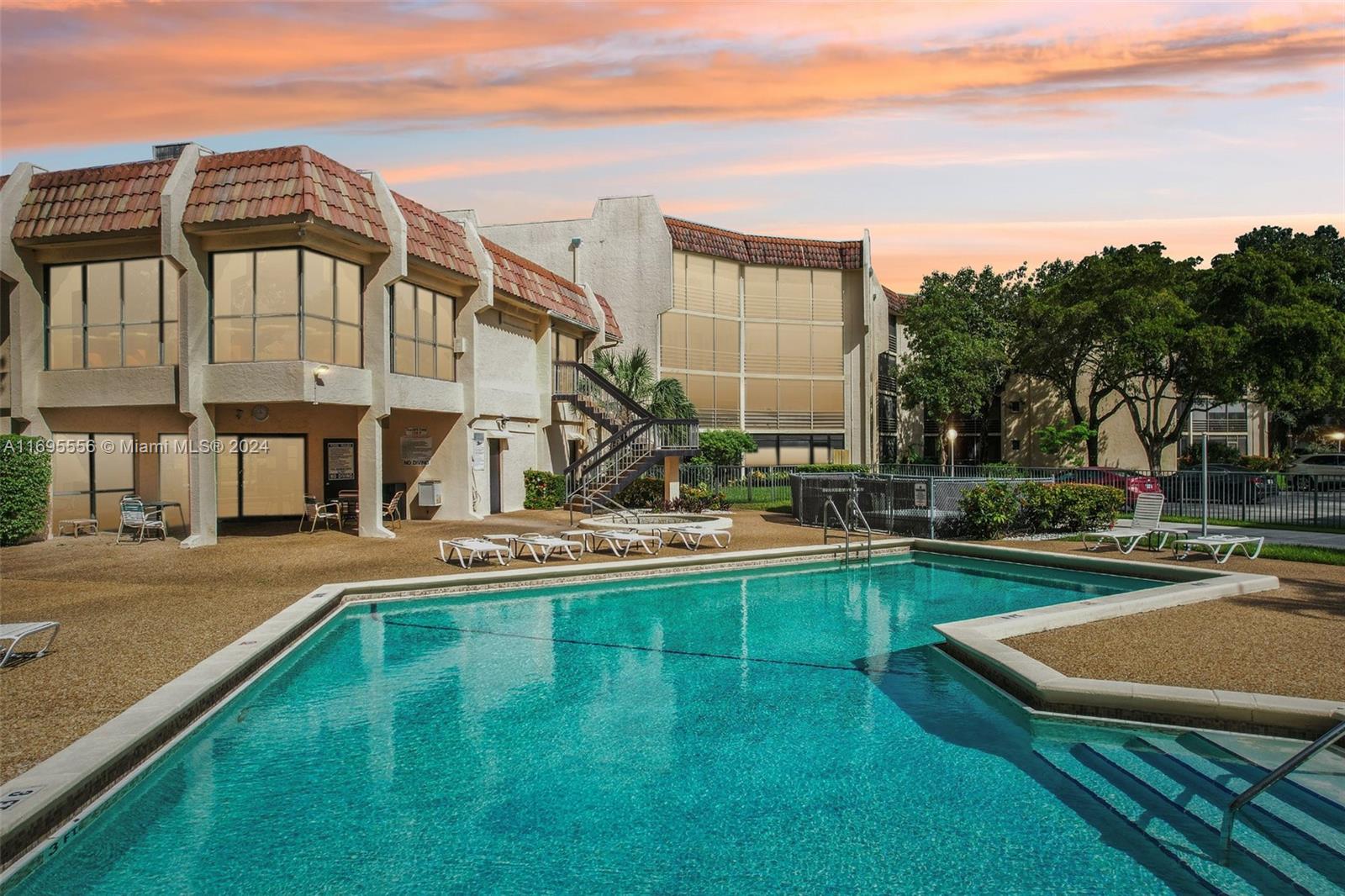 a view of a house with swimming pool and sitting area