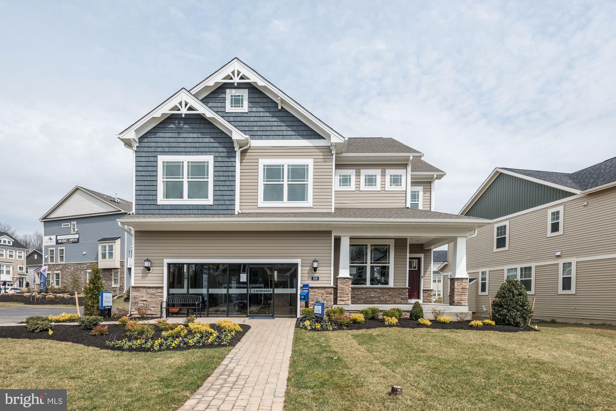 a front view of a house with a yard outdoor seating and garage