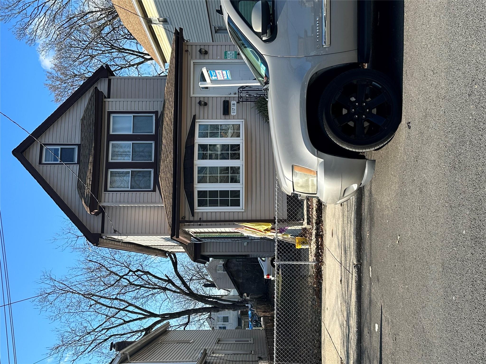 a view of building with car parked