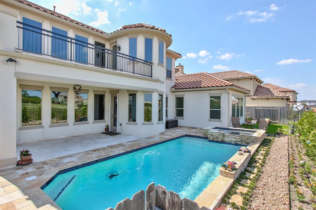 a front view of a house with swimming pool and porch