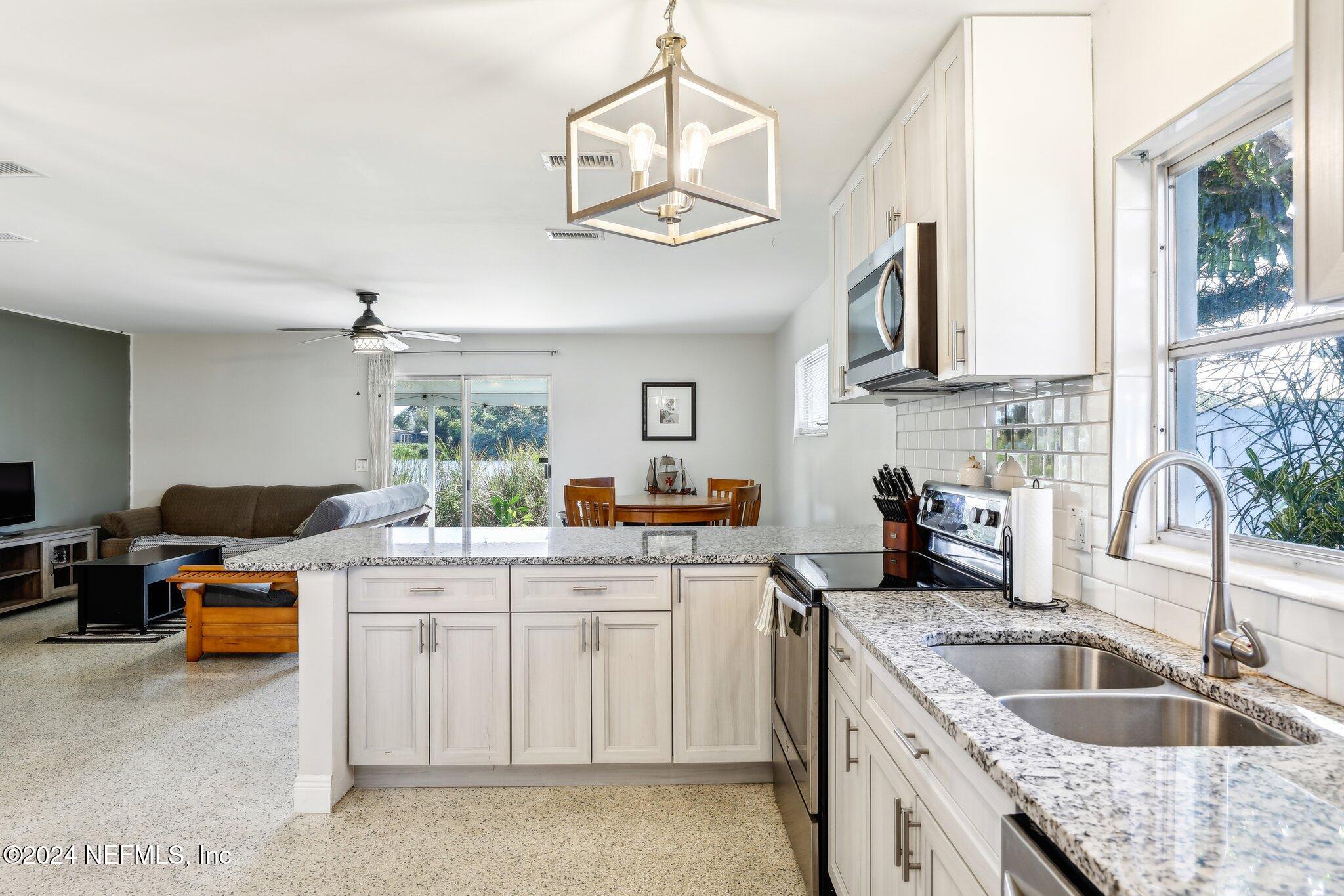 a kitchen with a sink cabinets and window