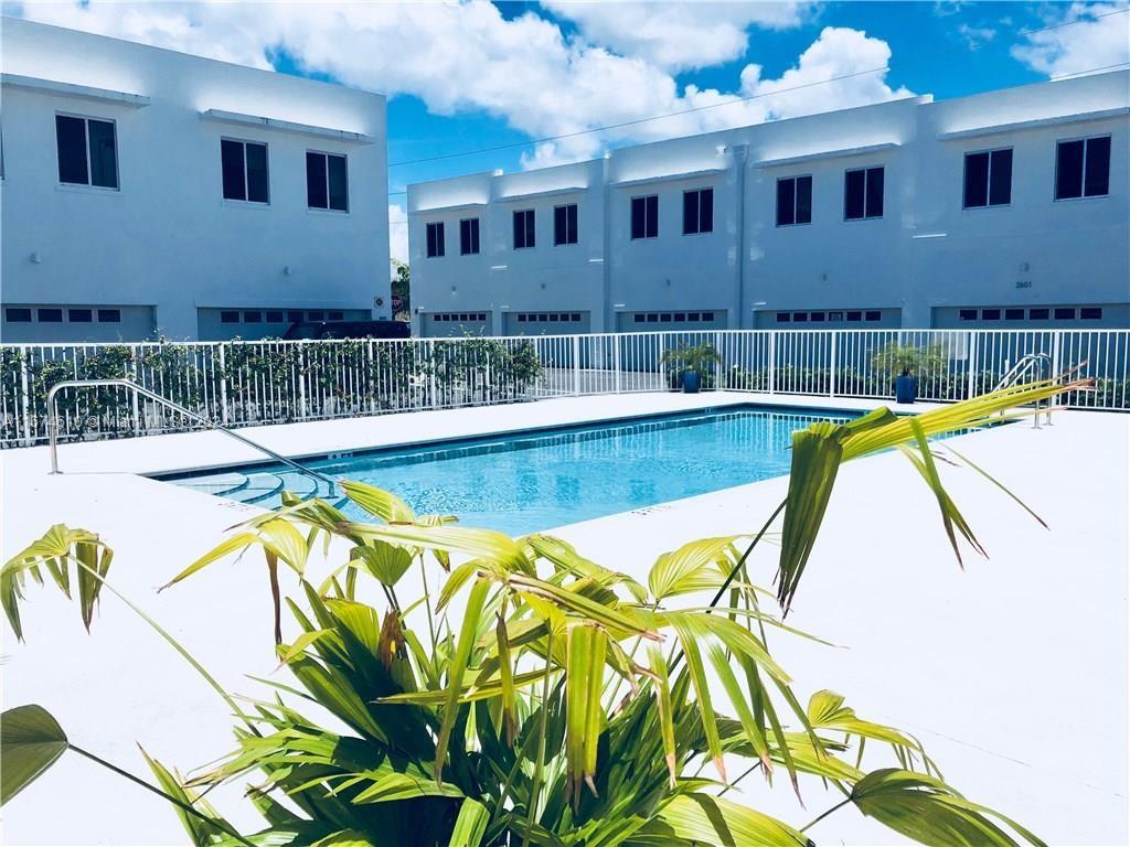 a view of a swimming pool with outdoor seating