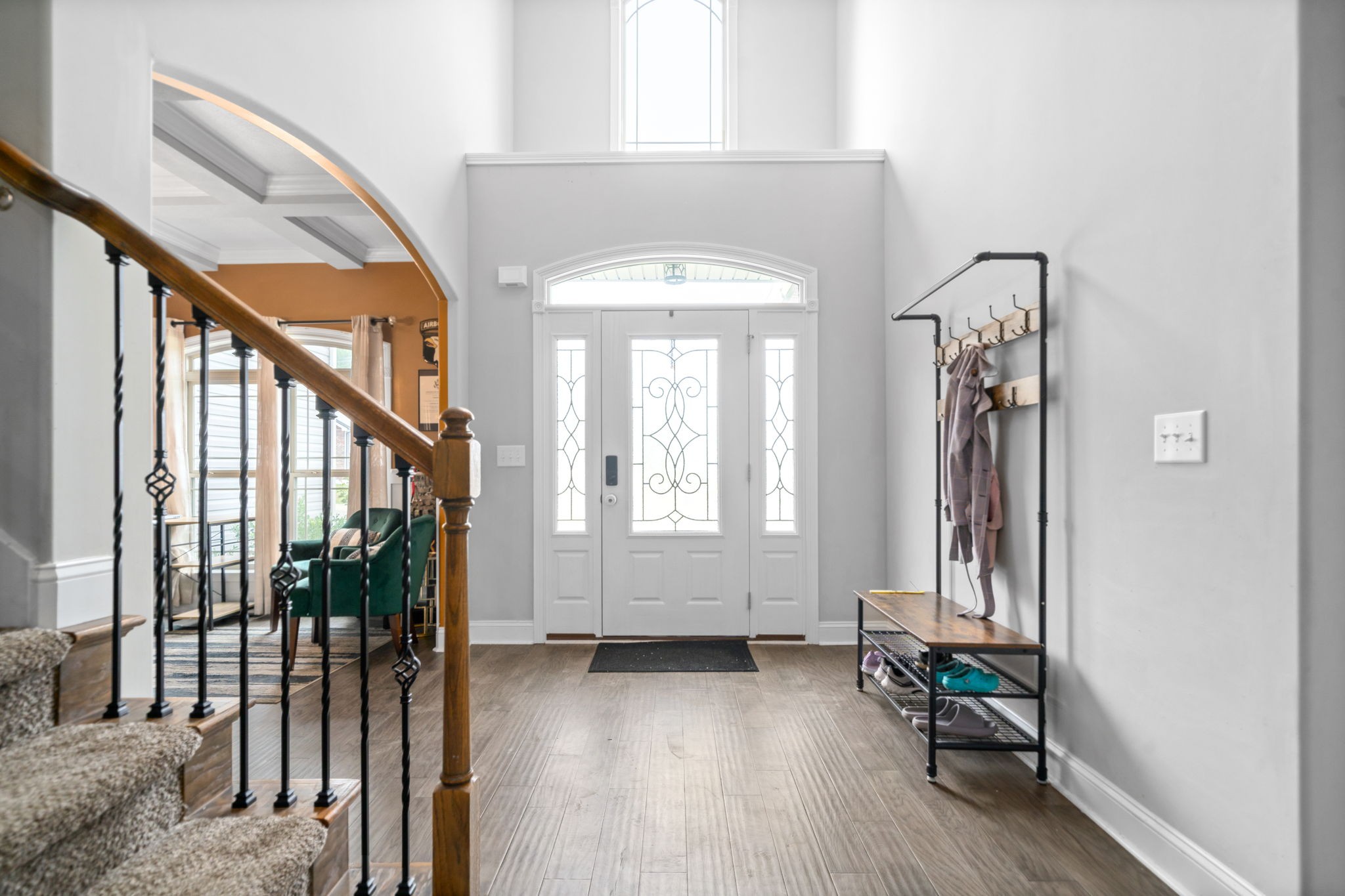 a view of entryway with wooden floor and stairs