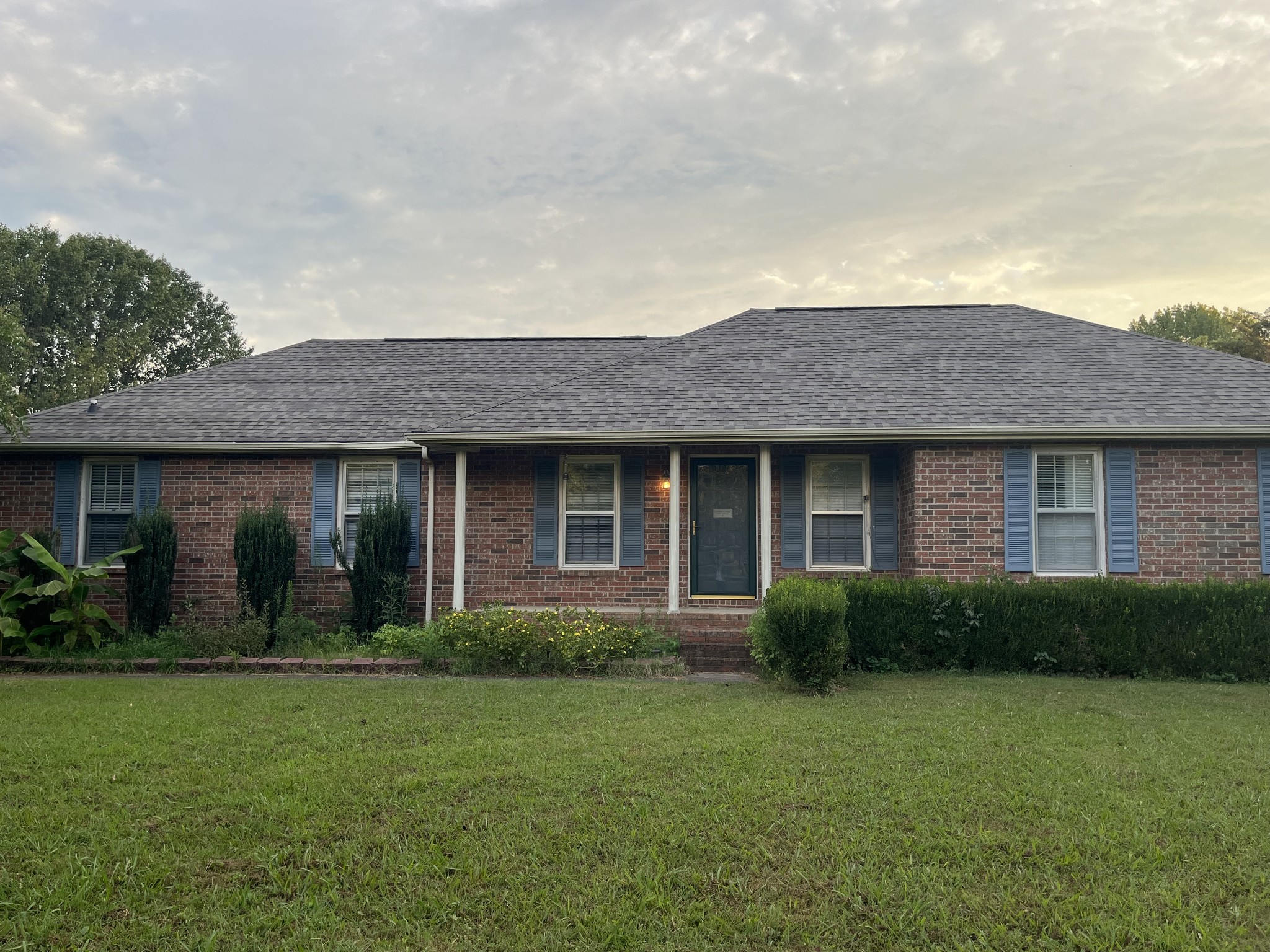 a front view of a house with a garden