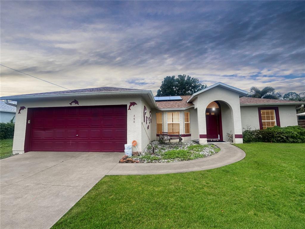 a front view of a house with a yard and garage