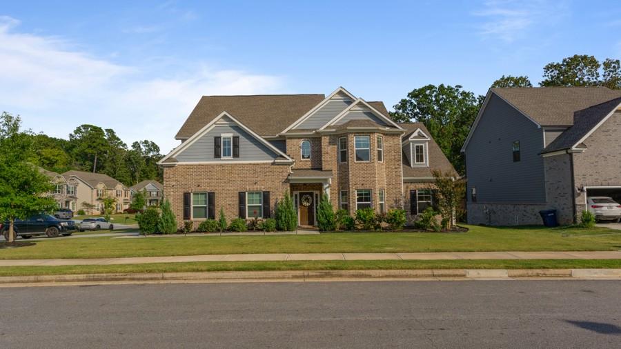 a front view of a house with a garden