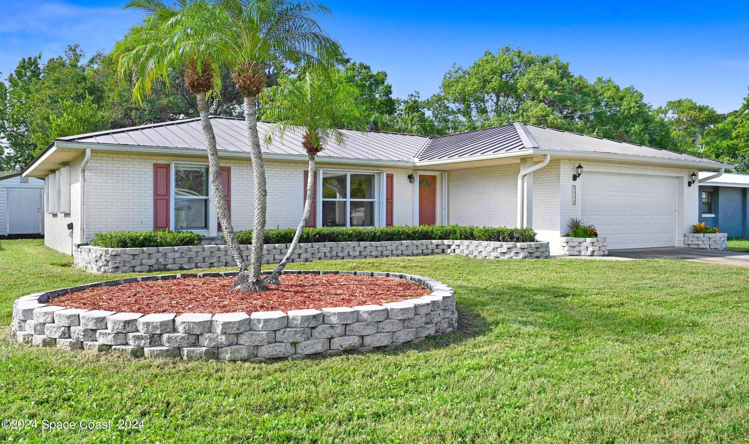 a front view of house with yard and green space