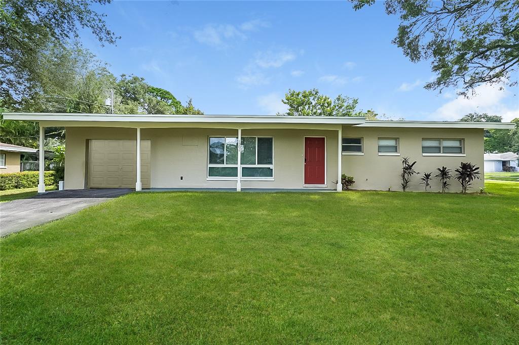 a front view of house with yard and green space