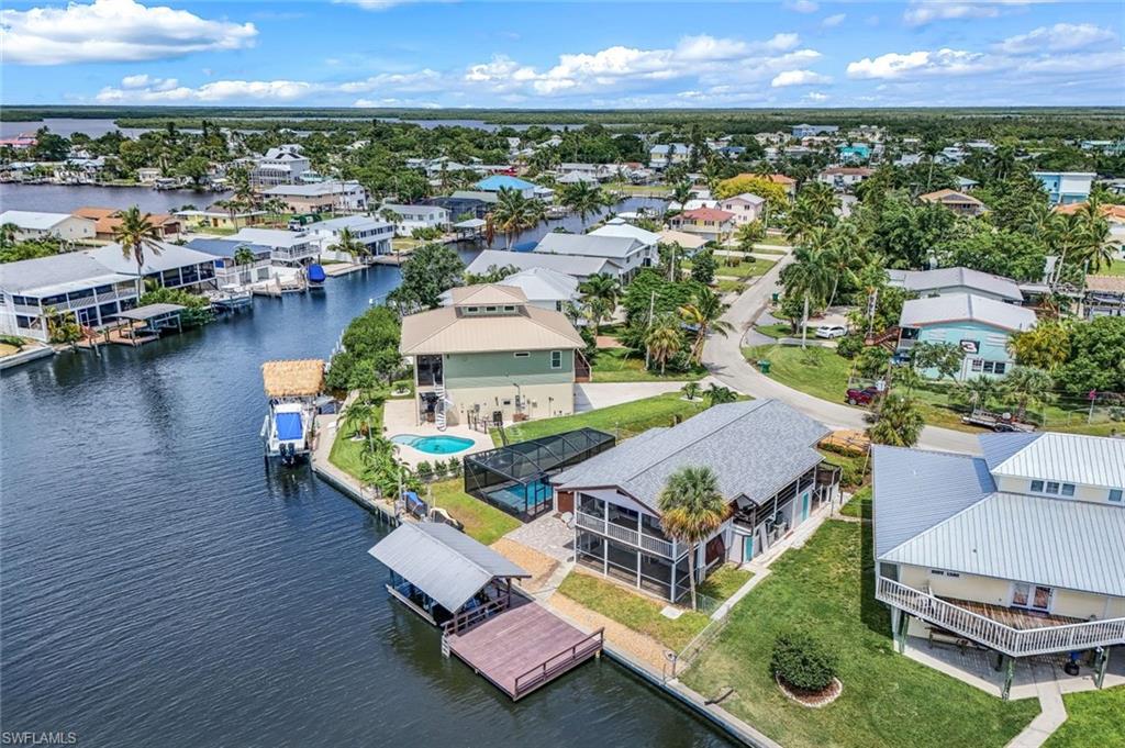 an aerial view of a house with a garden and lake view